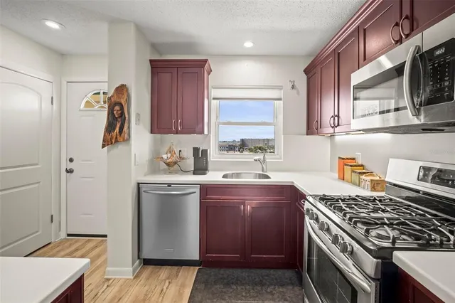 a kitchen with stainless steel appliances granite countertop a stove and a sink