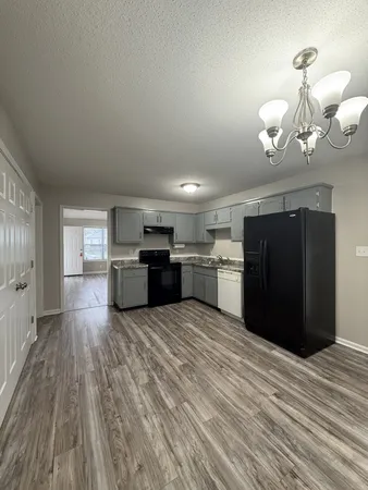 a view of a kitchen with a sink and a refrigerator