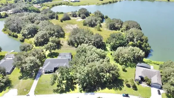 an aerial view of a house with a yard and garden