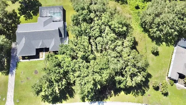 an aerial view of a house with a yard