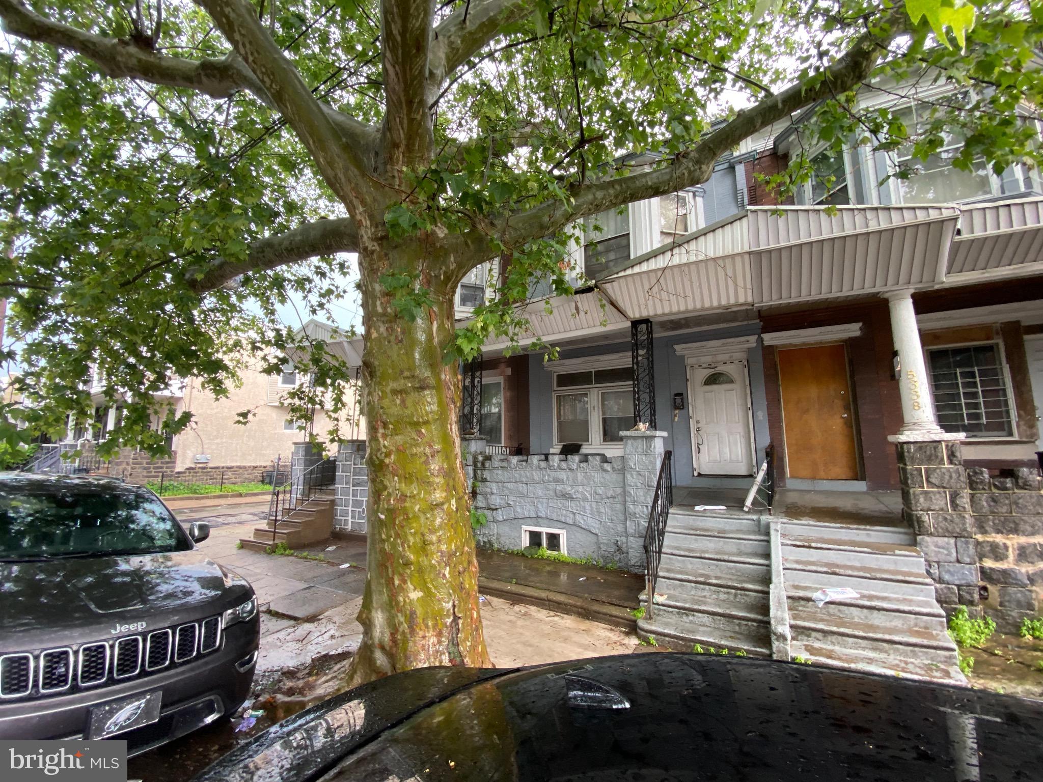 a view of a house with a large tree