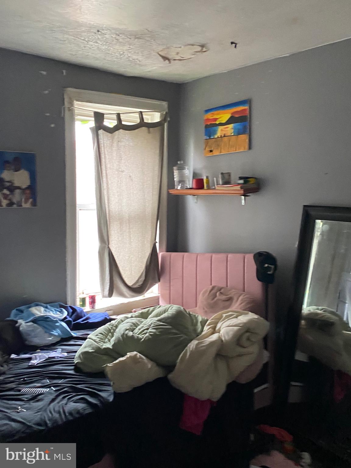 5336 Race Street Philadelphia, PA 19139 - Photo 16 of 23 a bed sitting in a bedroom next to a window