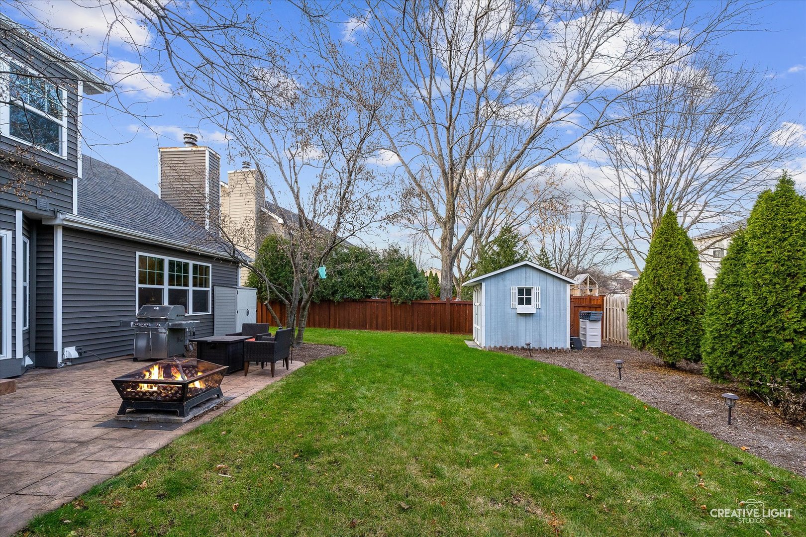 1185 Lewis Road Geneva, IL 60134 - Photo 25 of 28 a front view of a house with a yard and trees