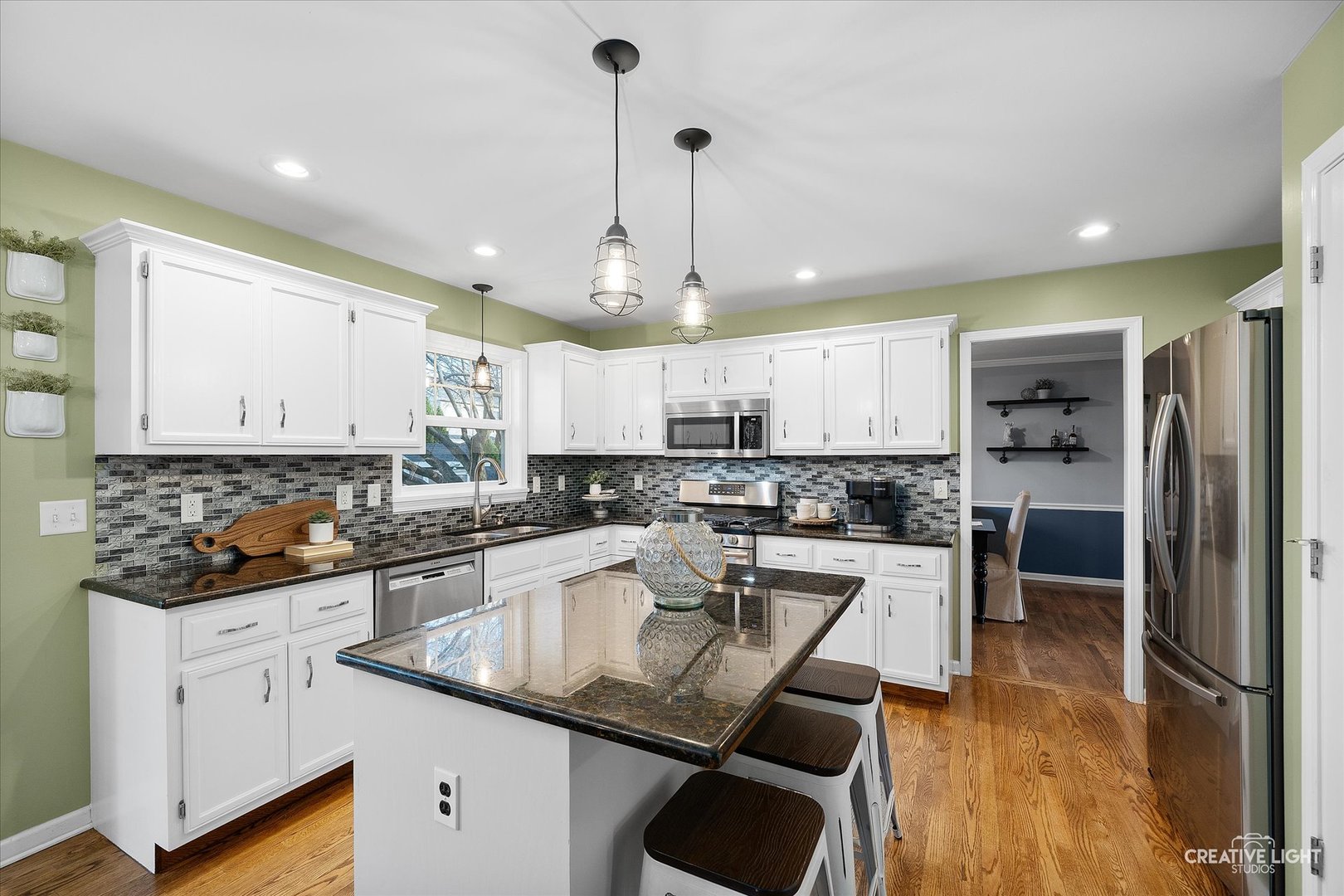 1185 Lewis Road Geneva, IL 60134 - Photo 8 of 28 a kitchen with a sink a counter top space stainless steel appliances and cabinets