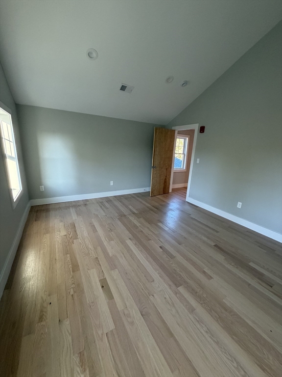 944 East Street, Unit 3 Walpole, MA 02081 - Photo 18 of 23 an empty room with wooden floor and windows