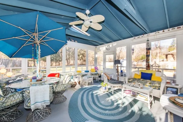 a view of a house with backyard water fountain and sitting area
