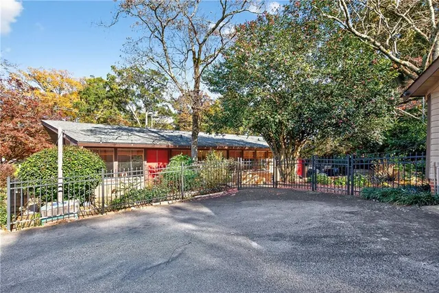 a view of backyard with outdoor seating and trees