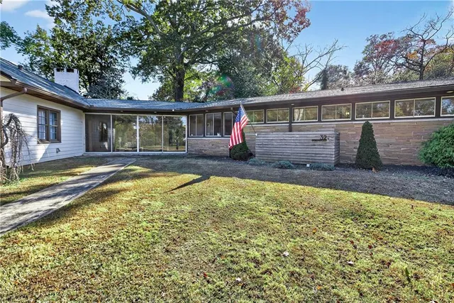 a view of a house with swimming pool and porch with furniture