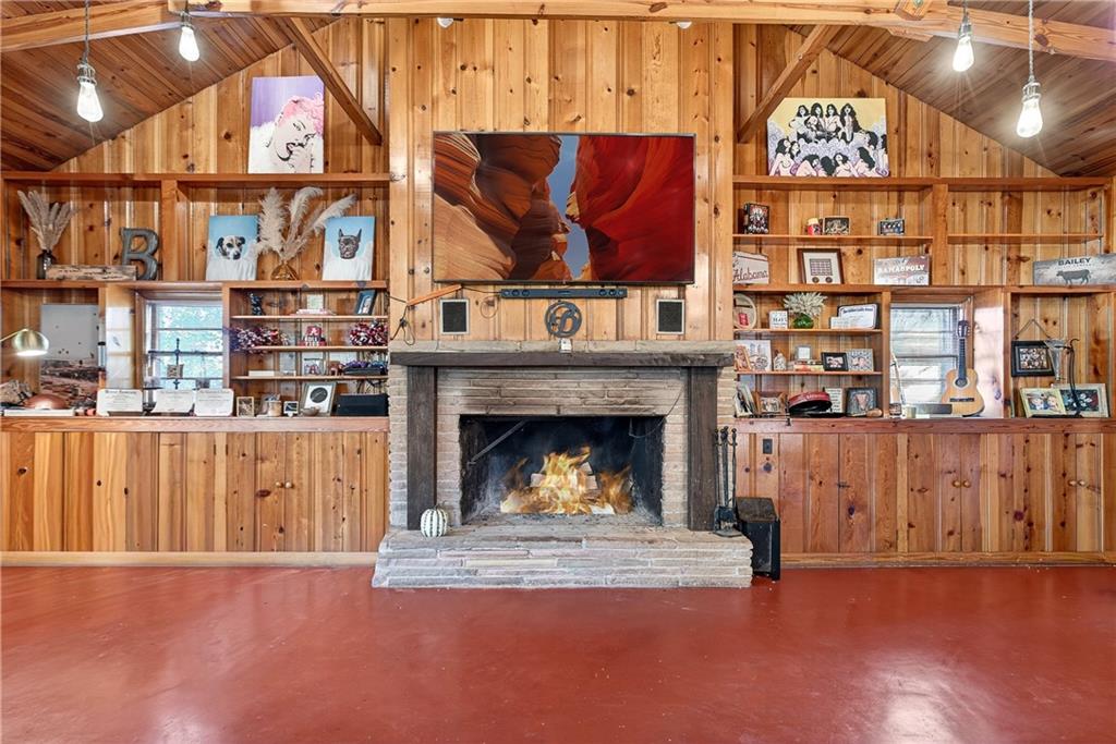 32 McDonough Street Hampton, GA 30228 - Photo 32 of 59 a living room with furniture a fireplace and a flat screen tv