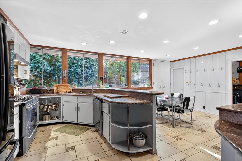 32 McDonough Street Hampton, GA 30228 - Photo 39 of 59 a kitchen with stainless steel appliances granite countertop a stove and a sink