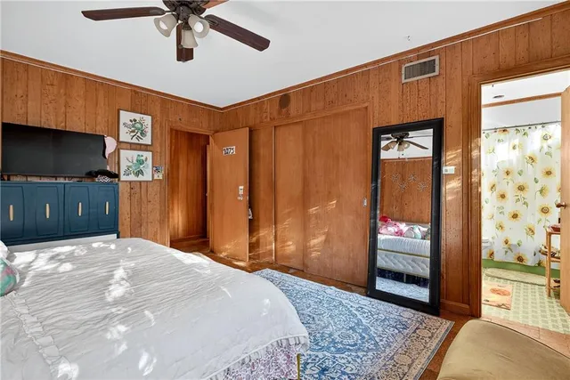 a bed sitting in a spacious bedroom next to a window