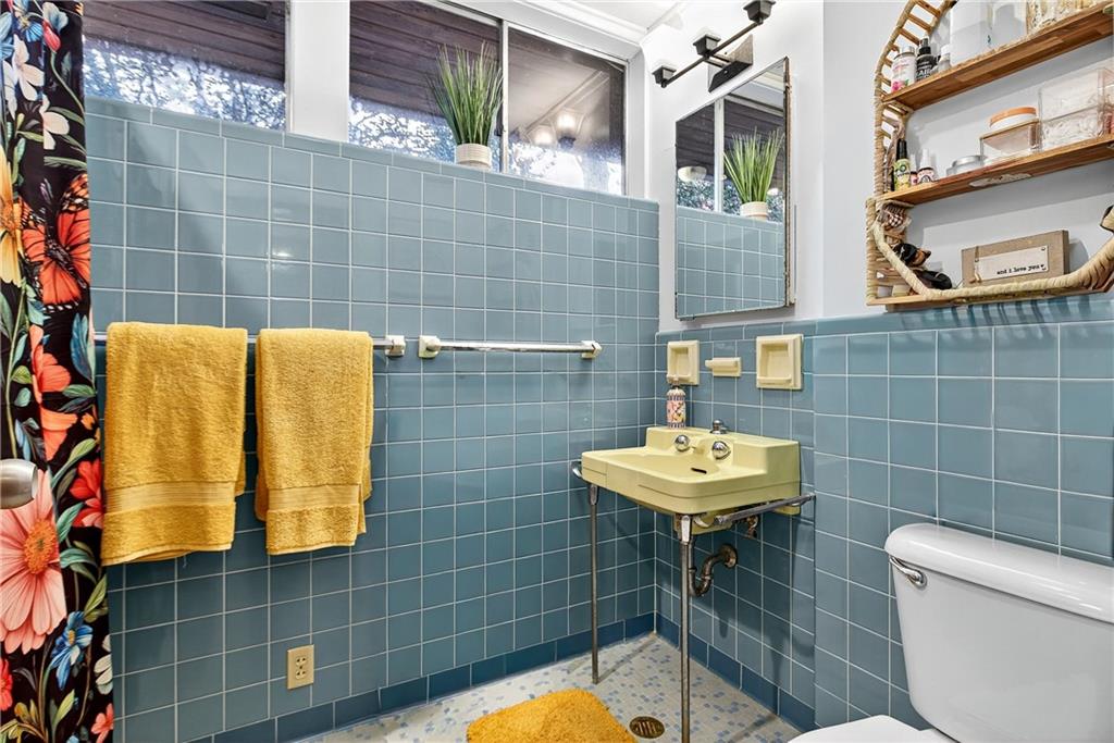 32 McDonough Street Hampton, GA 30228 - Photo 58 of 59 a bathroom with a sink a toilet and mirror