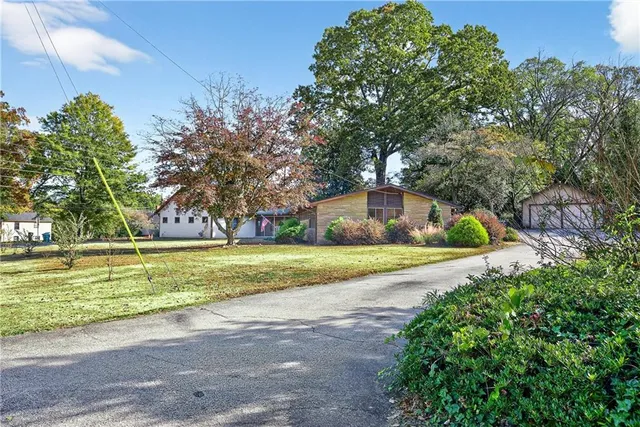 a front view of a house with a yard and a garage