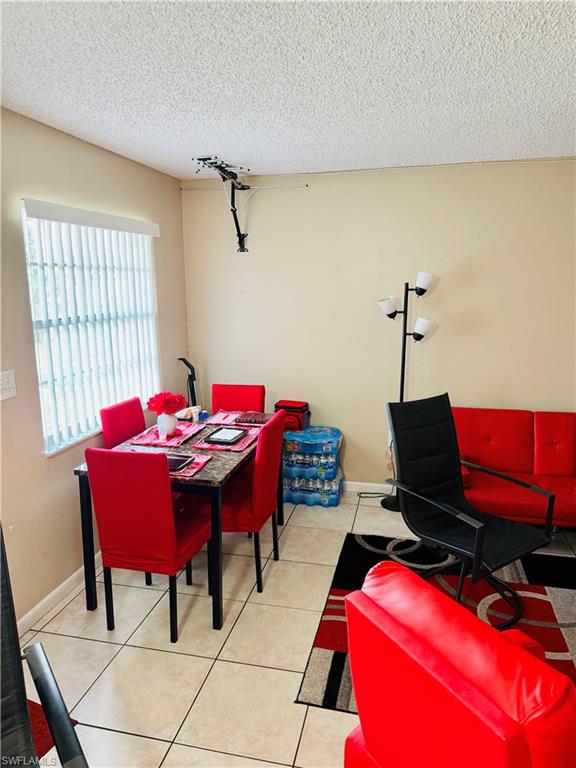 3325 Airport Road North, Unit R6 Naples, FL 34105 - Photo 3 of 11 Dining room featuring a textured ceiling and light tile patterned floors