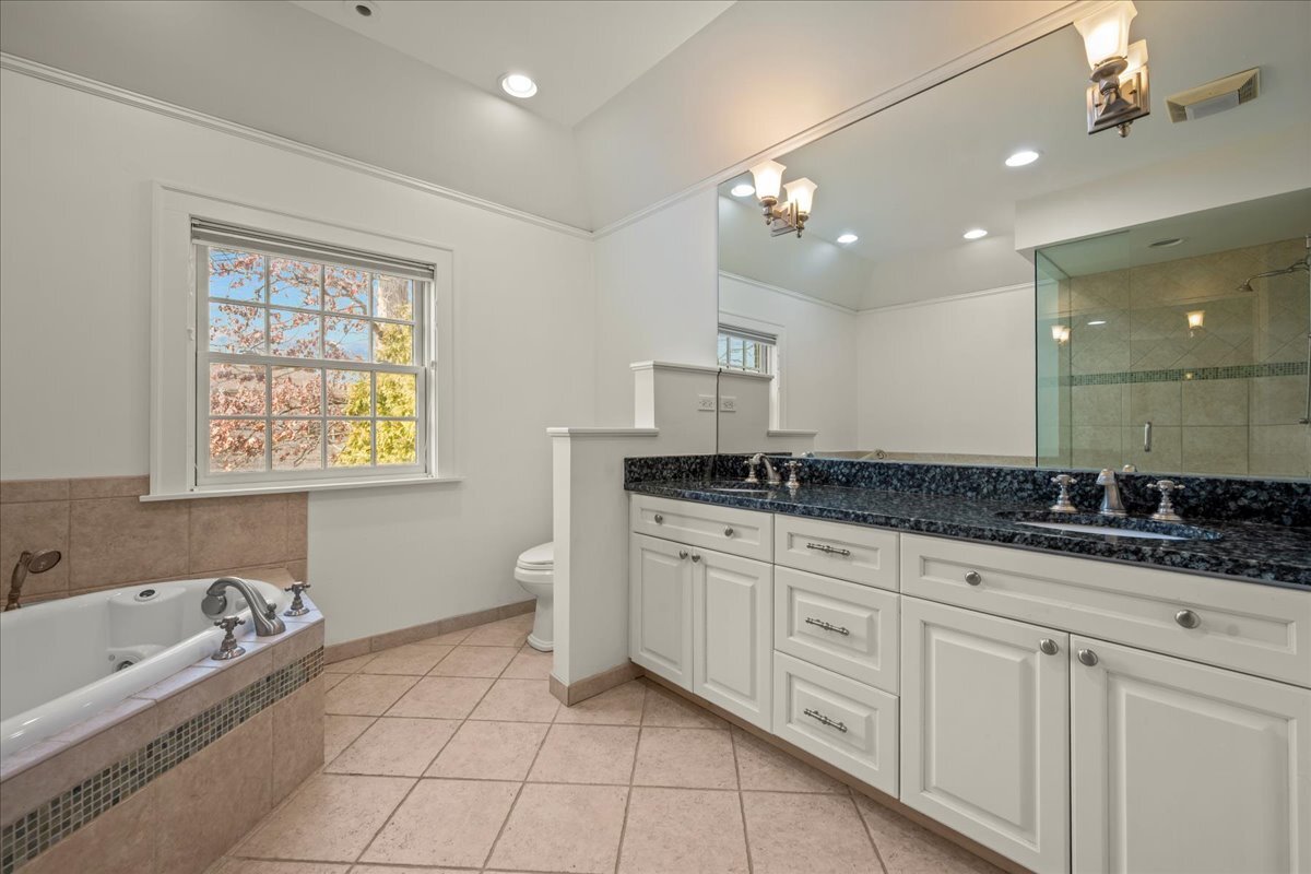 1878 Sunset Road Highland Park, IL 60035 - Photo 19 of 40 a bathroom with a granite countertop sink a large mirror and a bathtub