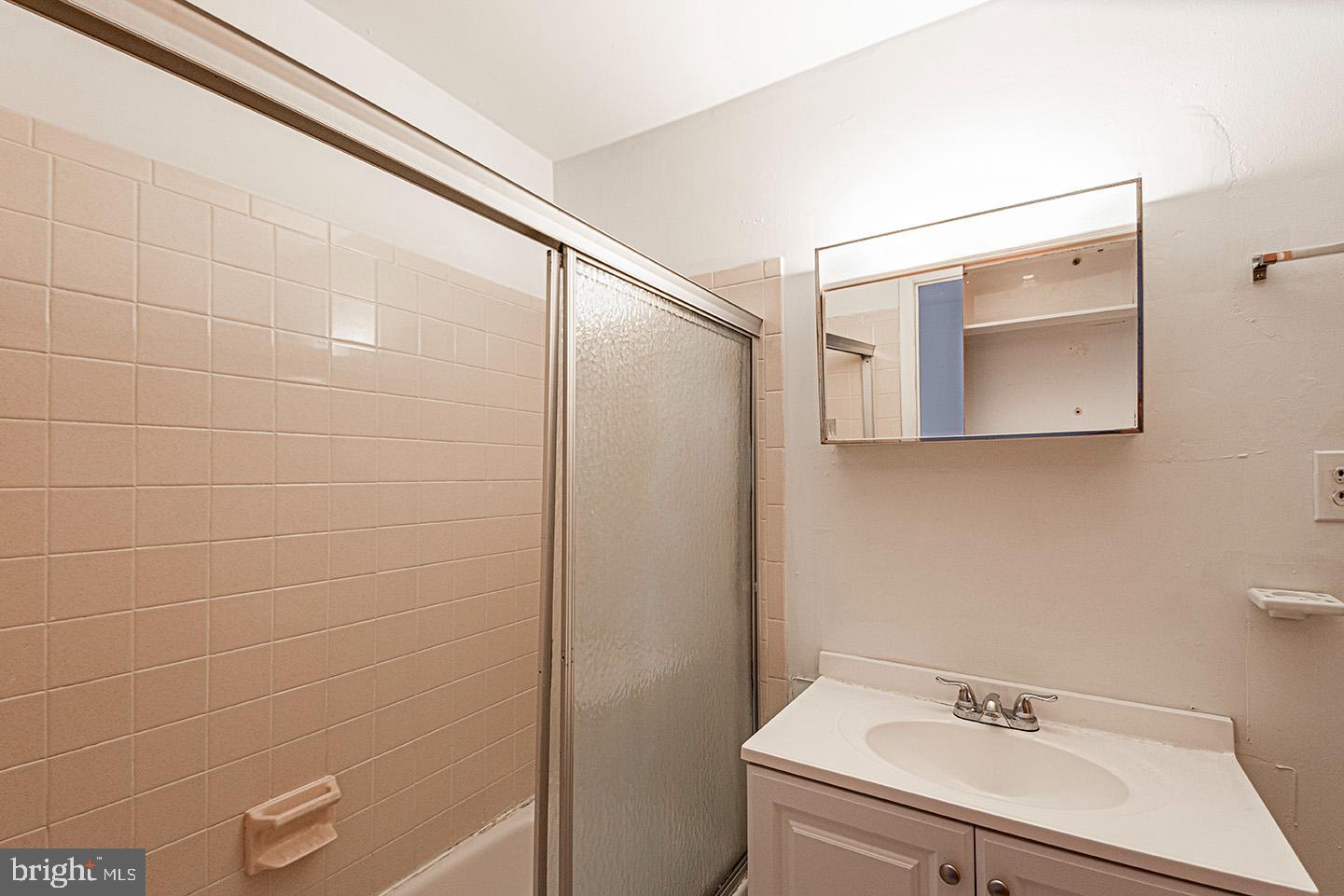 4118 Baltimore Avenue, Unit A Philadelphia, PA 19104 - Photo 14 of 25 a bathroom with a sink a toilet and shower
