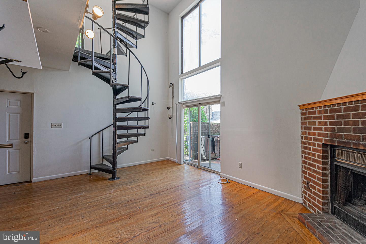 4118 Baltimore Avenue, Unit A Philadelphia, PA 19104 - Photo 2 of 25 wooden floor in an empty room with a fireplace