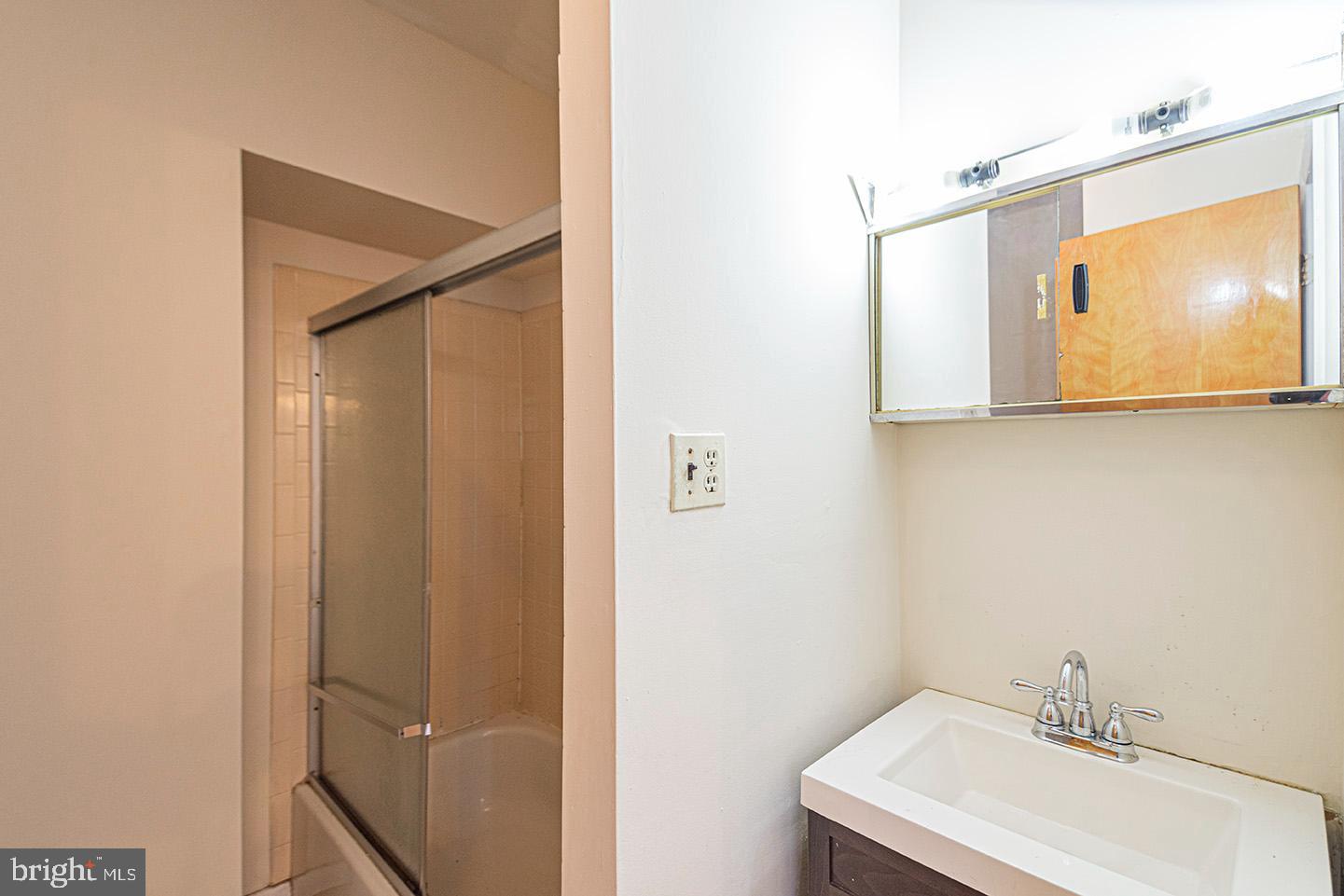 4118 Baltimore Avenue, Unit A Philadelphia, PA 19104 - Photo 21 of 25 a bathroom with a sink and mirror