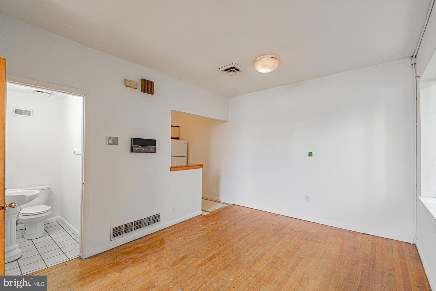 4118 Baltimore Avenue, Unit A Philadelphia, PA 19104 - Photo 6 of 25 a view of a livingroom with wooden floor and a bathroom