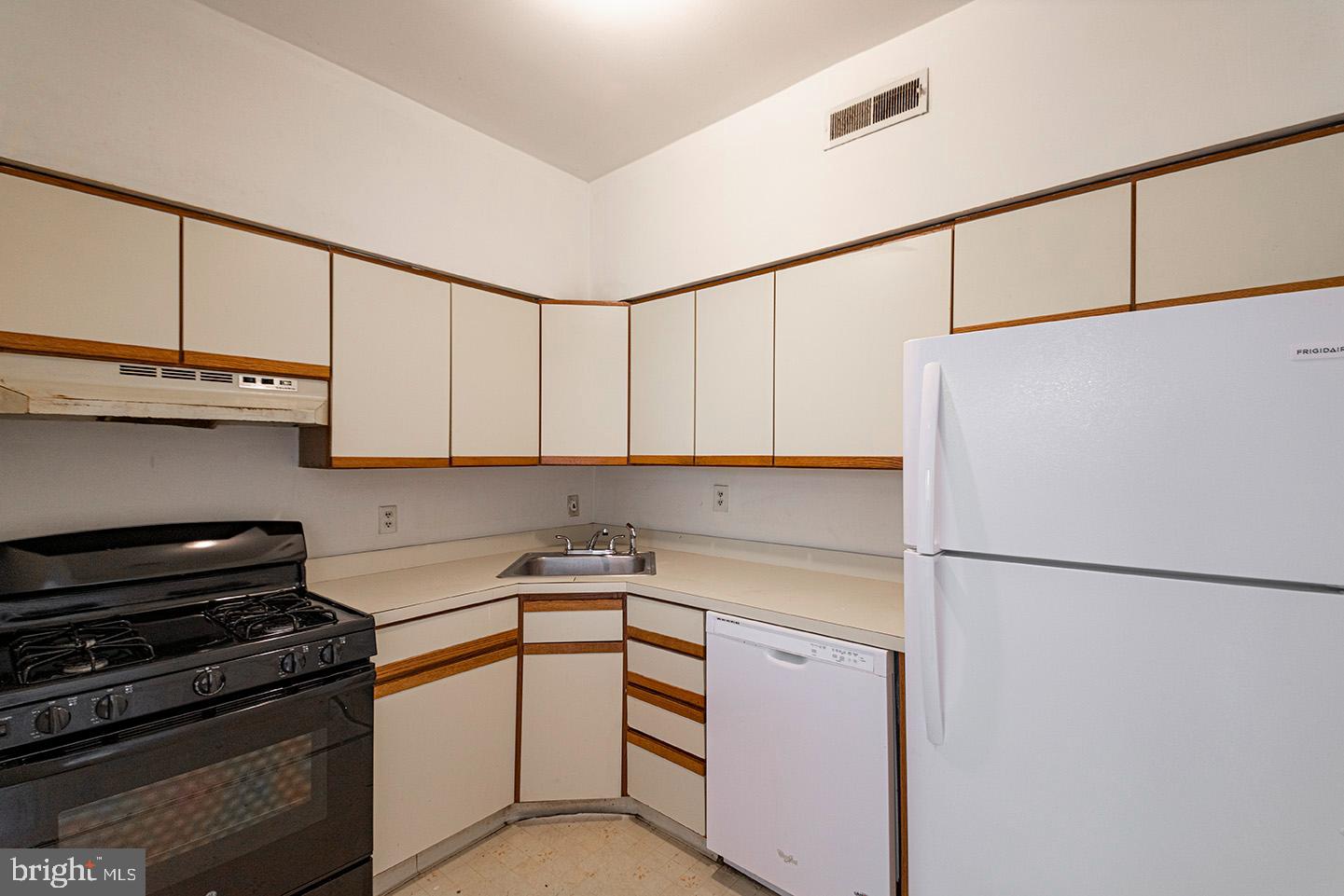 4118 Baltimore Avenue, Unit A Philadelphia, PA 19104 - Photo 8 of 25 a kitchen with stainless steel appliances a refrigerator sink and cabinets