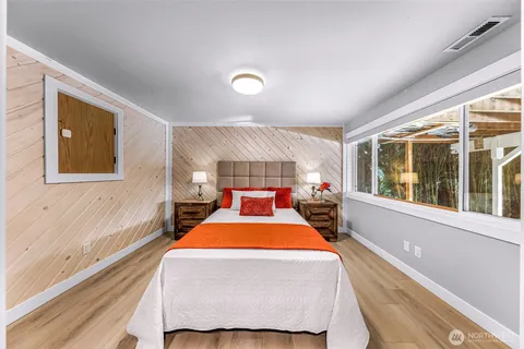 a bed room with a bed and a large window