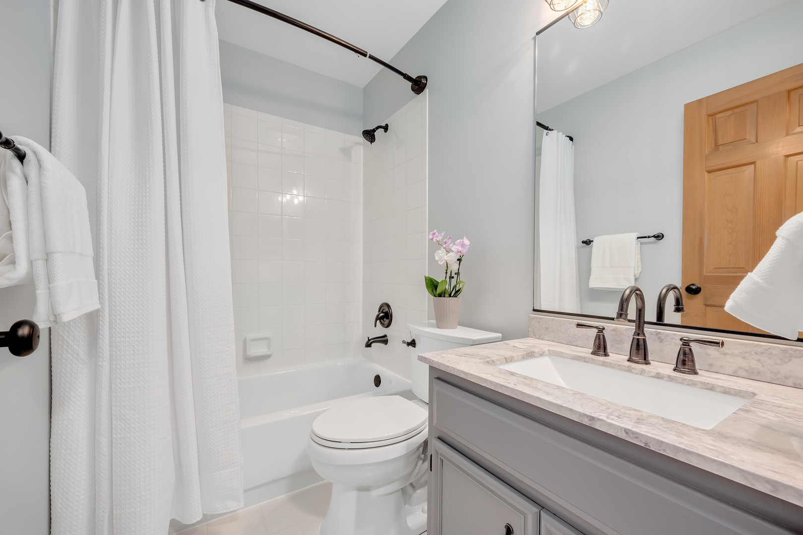2499 Highland Road Geneva, IL 60134 - Photo 16 of 29 a bathroom with a granite countertop sink a toilet and shower