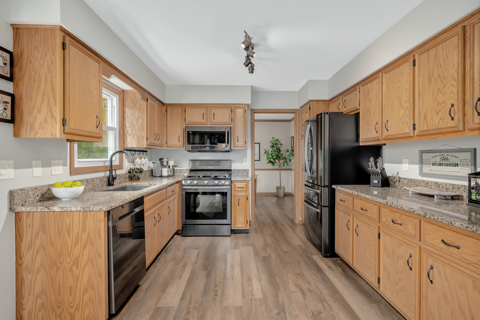 2499 Highland Road Geneva, IL 60134 - Photo 7 of 29 a kitchen with granite countertop a sink cabinets stainless steel appliances and a window