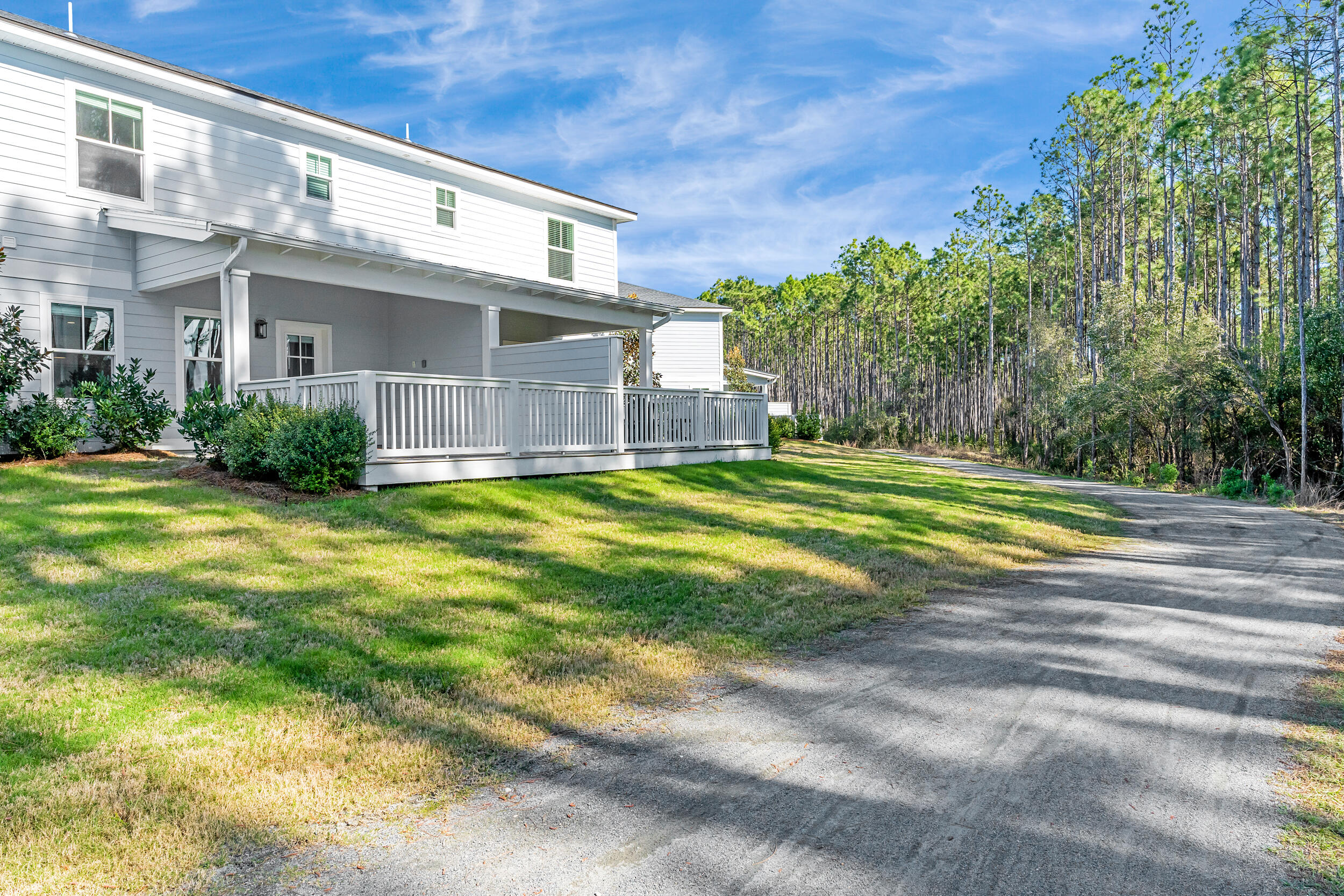 115 Golden Bell Court, Unit 115B Inlet Beach, FL 32461 - Photo 3 of 47 a view of a house with a big yard and large trees