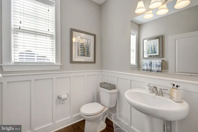 a bathroom with a sink a toilet a large mirror and shower