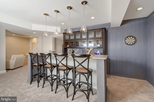 a kitchen with a refrigerator and white cabinets