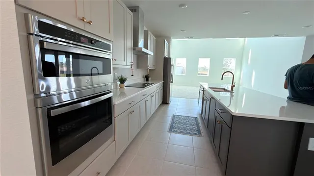 a kitchen with kitchen island granite countertop a stove and a sink