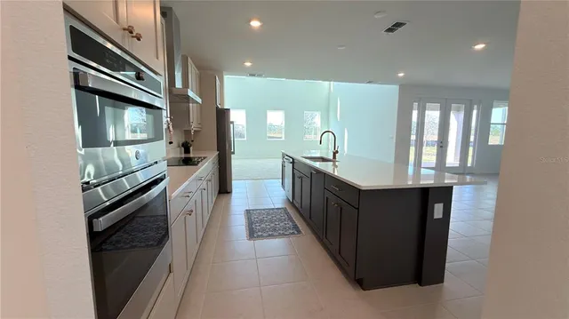 a kitchen with stainless steel appliances granite countertop a refrigerator and a stove