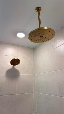 a bathroom with a sink toilet double vanity and tub