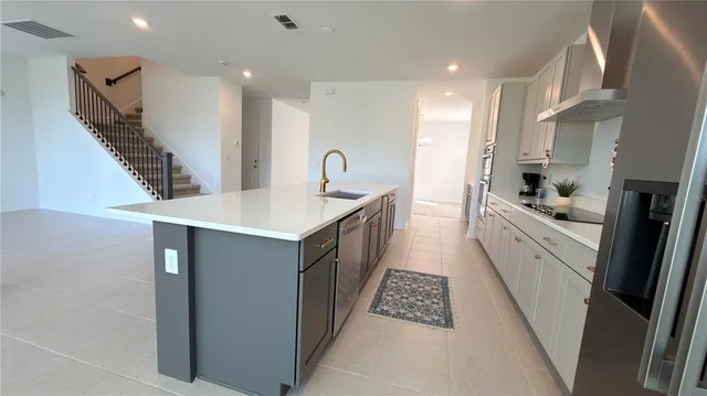 a kitchen with stainless steel appliances a stove a microwave and a refrigerator