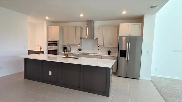 a kitchen with a sink and refrigerator