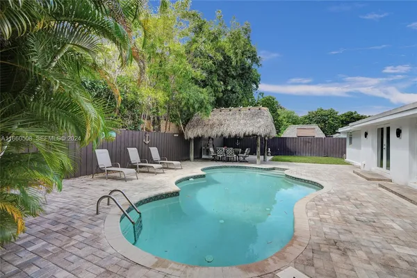 a view of a house with backyard porch and sitting area