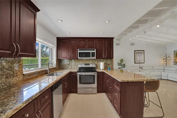 a kitchen with a sink stove top oven and microwave