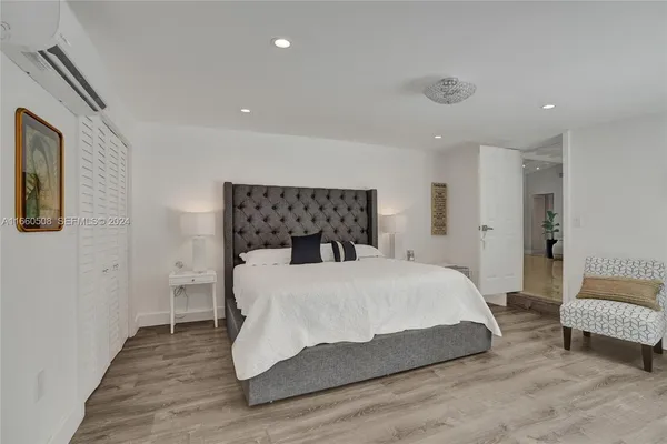 a bedroom with a bed and a couch