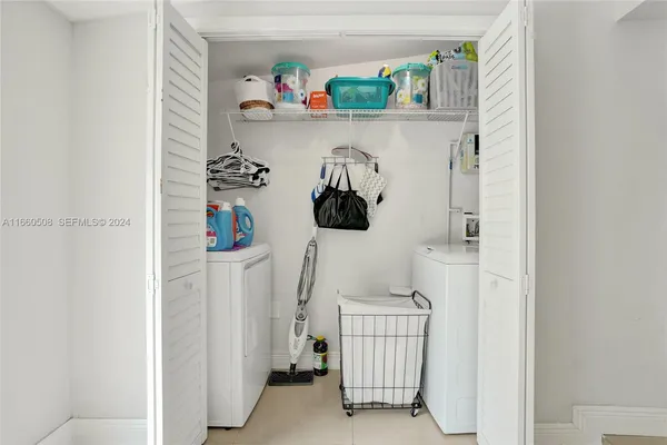 walk in closet with window and way to kitchen