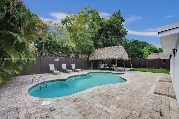 a swimming pool with outdoor seating and yard