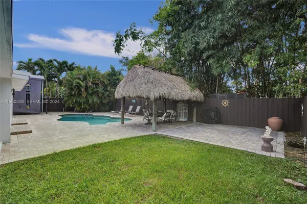 a backyard of a house with table and chairs