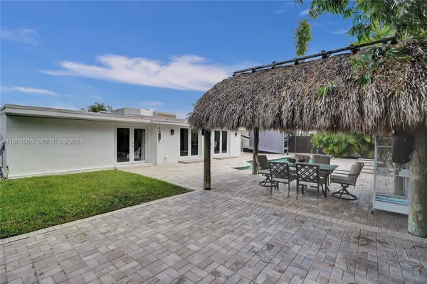 a view of a patio with table and chairs with wooden fence