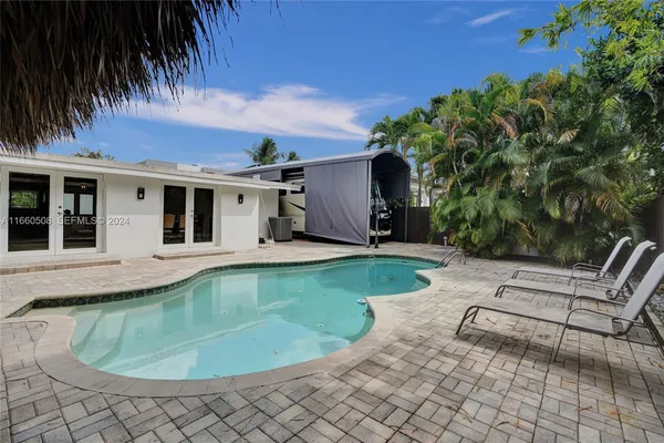 a view of a house with swimming pool and a yard