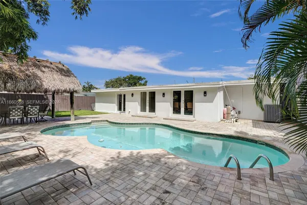 a house with swimming pool in front of it
