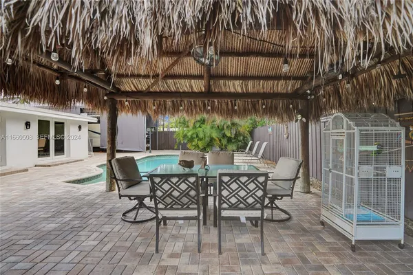 a view of a patio with table and chairs and potted plants