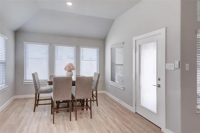 a spacious bedroom with a bed and a flat screen television