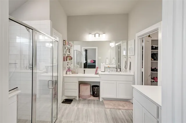 a bathroom with a glass shower door