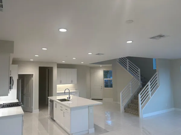 a view of a kitchen with refrigerator and microwave