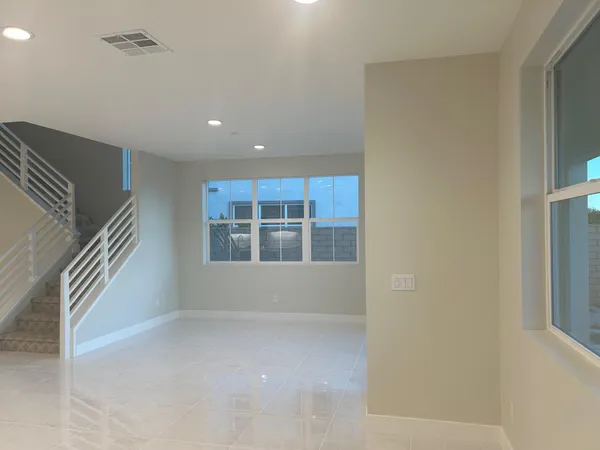 a kitchen with stainless steel appliances kitchen island granite countertop a refrigerator and a sink