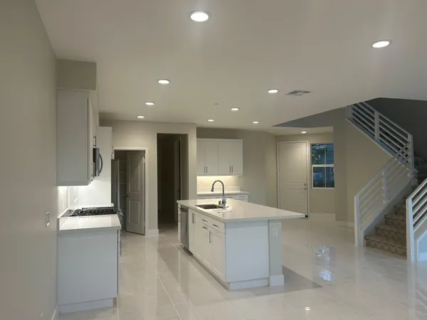 a kitchen with a sink stove and refrigerator